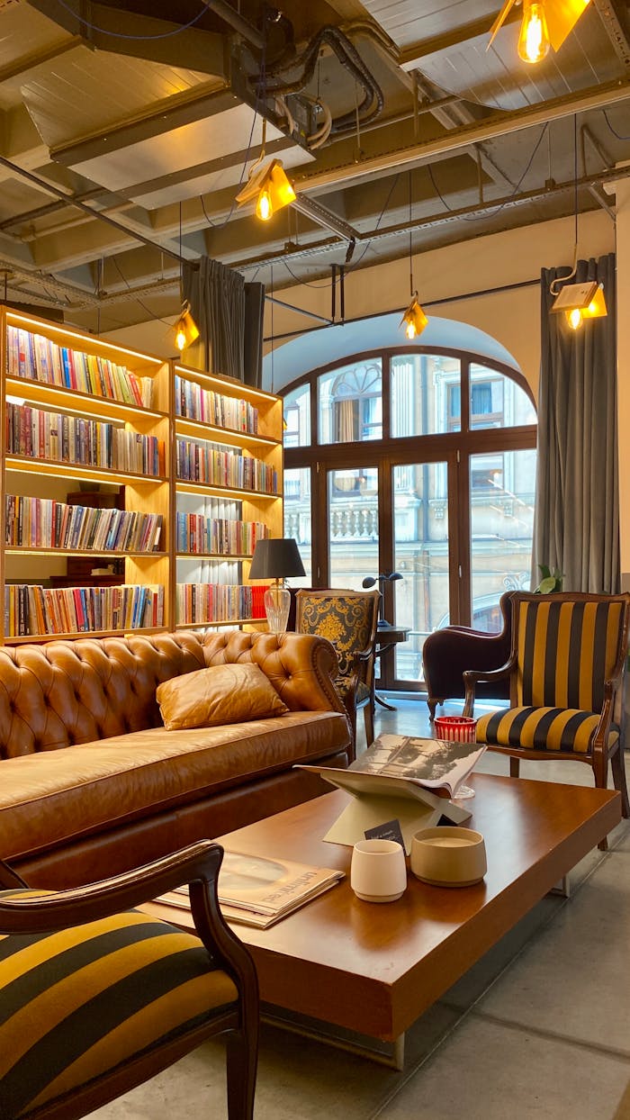 Home Elegant bookstore interior featuring leather sofa, bookshelves, and natural lighting.